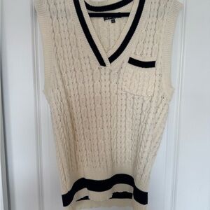 Cream sweater vest with black and pocket details